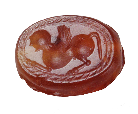Scarab – carnelian seal; the seal represents a winged sphinx, with human head